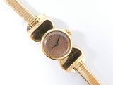 an image of a close up of a wrist watch on a white surface