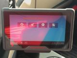 someone is holding a tablet in their hand in a car