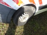a white car with a red stripe painted on the side of it