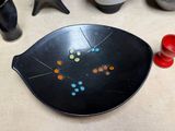 a black plate with colorful buttons on it on a table