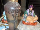 deux figurines posées sur une table à côté d'une lampe