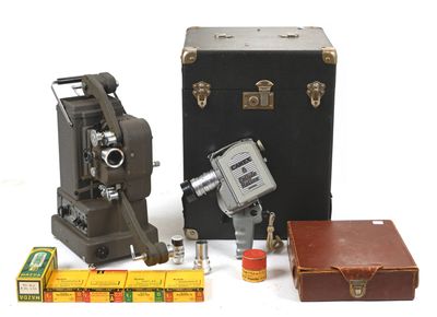 two old cameras, a box, and a ruler on a white surface