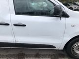 a small white van parked in a parking lot