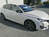 the white car is parked in front of a garage