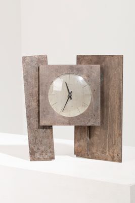 une horloge en bois posée sur une table blanche