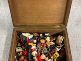 a small wooden box filled with assorted toy figurines