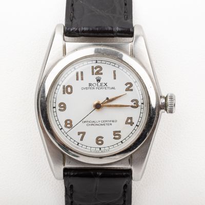 an image of a close up of a wrist watch on a white surface