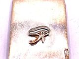an image of a silver pendant with an egyptian eye on it