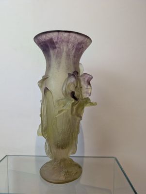 a glass table with a vase on top of it