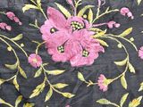 an image of a close up of a black fabric with pink flowers on it