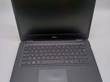 a dell laptop computer sitting on a white table