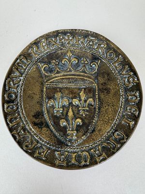 a close up of a coin with a crown on it