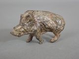 a small figurine of a boar on a table