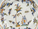 an image of a decorative plate with blue and orange flowers on it