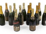bottles of champagne are lined up in a row on a white surface