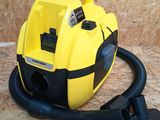 a yellow and black blow dryer sitting on a wooden floor