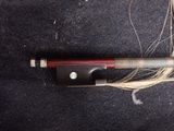a knife that is laying on top of a piece of hair
