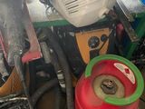 a pile of assorted items on the floor of a garage