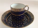 a cup and saucer sitting on a saucer