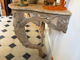 a marble table with a vase on top of it