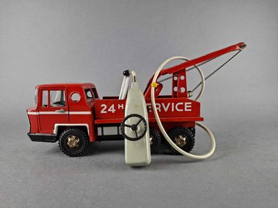 a toy fire truck with a hose attached to the back of it