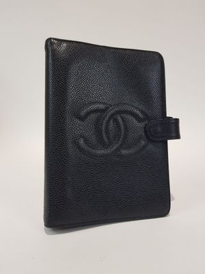 a black chanel wallet with a chanel logo on the front