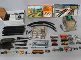a lot of toy train tracks and accessories on the table