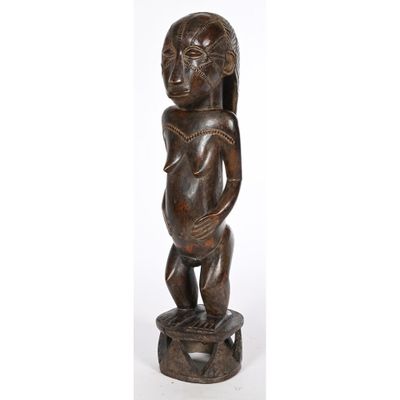 a wooden statue of a woman holding a baby