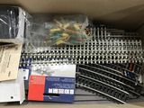 a box full of train tracks and other items in it