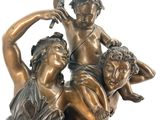an image of a bronze statue of two women and a child