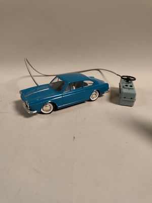 une petite voiture et une télécommande posées sur une table