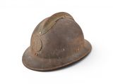 an old helmet on a white surface with a white background