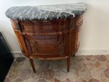 a marble top cabinet in the corner of a room