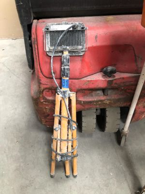 a picture of a red truck with a ladder attached to the front of it