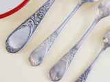 five spoons and two spoons sitting on a table