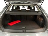 the trunk of a car with a red blanket in the trunk