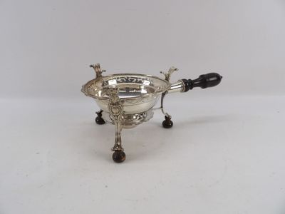 an antique silver plated sugar bowl with a black handle