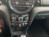 a dashboard of a small car with a clock on it