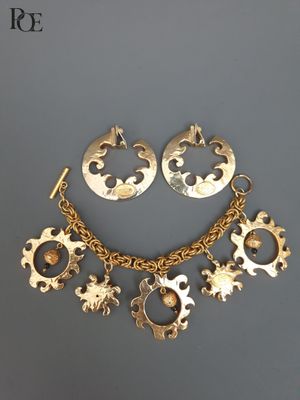 un gros plan d'un collier et de boucles d'oreilles posés sur une surface grise