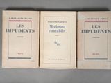 three books sitting on top of a table next to each other