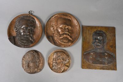 three bronze medallions of a man and a woman