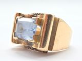 an image of a gold ring with a blue stone in the center