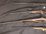 several different types of guns are lined up on a black cloth