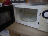 a microwave with a bowl inside of it on a counter