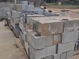 concrete blocks stacked on top of each other in a yard