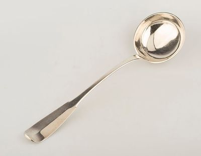 a silver spoon with a spoon handle on a white surface
