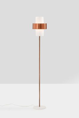 a copper floor lamp with a marble base and a white shade