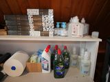 a shelf with many bottles of cleaning products on it