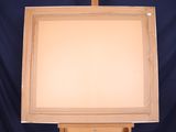 a wooden easel with a light on top of it on a blue background