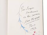 an open book with a drawing of a woman ' s face on it